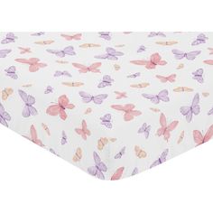 a white sheet with pink and purple butterflies printed on it's side, next to a pillow