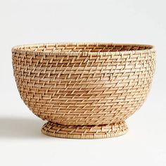 a wicker bowl sitting on top of a white table