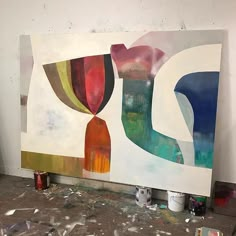 an abstract painting being worked on in a studio