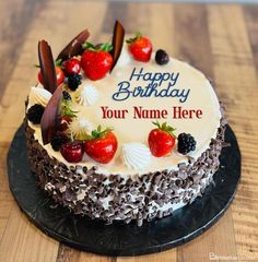 a birthday cake with strawberries and chocolates on the top that says, happy birthday your name here