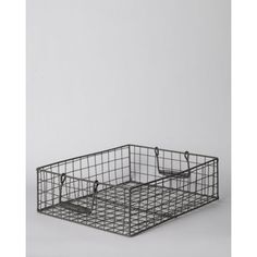 a metal basket with two handles on the bottom and one in the middle, against a white background