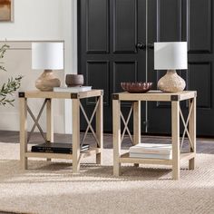 two end tables with lamps on them in front of a black door and carpeted floor