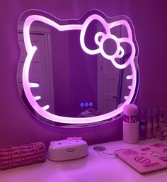 a hello kitty mirror sitting on top of a desk