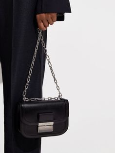 This product is made with at least 20% sustainable materials by weight. CHARLES & KEITH uses recycled, degradable, organic, and water-based materials in our eco-conscious collection. In sleek black and featuring silver-tone hardware, our Charlot bag will put the perfect finishing touches on your grunge-inspired outfits. Featuring a sliding chain strap, you can alter the drop to suit your styling preferences. This statement piece has compact proportions that make it ideal for evenings in the city. Chain Strap Bag, Strap Bag, Charles Keith, Luggage Accessories, Eco Conscious, Inspired Outfits, Sustainable Materials, Bag Straps, Chain Strap