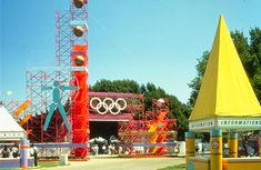 the olympic games are being displayed in front of an amusement park