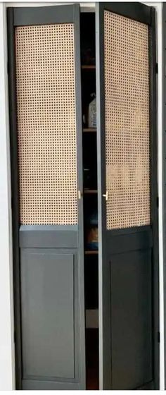 an open closet with wicker doors and shelves