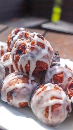 a white plate topped with donuts covered in icing