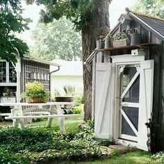 an outhouse in the middle of a yard