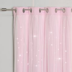 a pink curtain hanging on the side of a wall