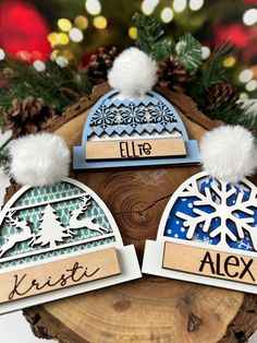 three personalized christmas ornament on top of a tree stump with snowflakes