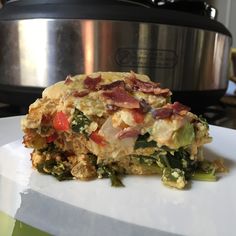 a casserole dish on a plate with an instant pot in the back ground