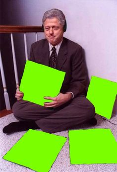 a man sitting on the floor with green squares in front of him