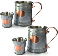 three metal mugs with copper colored handles