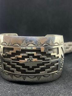 "Beautiful handmade Native American Navajo plain Sterling Silver Bracelet. Stamped sterling silver& signed by artist F.D. Conditions are new with tags. Silver work is very gorgeous and detailed. There is a black antique look design around the silver. Very gorgeous silver-work. The bracelet is also adjustable to fit the wrist. From one end to the other the bracelet is approximately 5 3/4 inches. The opening of the bracelet is approximately 1 3/4 inch's. . The bracelet is 1 9/16 inch's wide. Weigh Artisan Sterling Silver Bracelet, Handmade Southwestern Sterling Silver Bracelet, Western Style Silver Cuff Bracelet As A Gift, Artisan Silver Concho Cuff Bracelet, Handmade Western Silver Bracelets, Bohemian Cuff Bracelet With Polished Finish, Western Style Silver Cuff Bracelet Gift, Artisan Sterling Silver Concho Cuff Bracelet, Southwestern Stamped 925 Cuff Bangle Bracelet