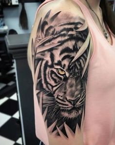 a woman with a tiger tattoo on her arm