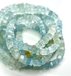 several pieces of glass beaded together on a white surface with one bead in the middle