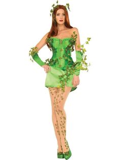 a woman dressed in a green costume with leaves on her head and hands behind her back