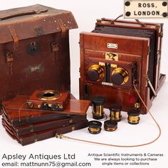 an old fashioned wooden camera and other antique items are displayed in front of a white background