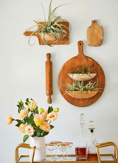 a table with flowers and cutting boards on the wall