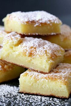 several pieces of cake sitting on top of a plate covered in powdered sugar and sprinkled with icing