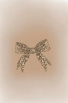 an animal print bow on a beige background with the word love written across it in black ink