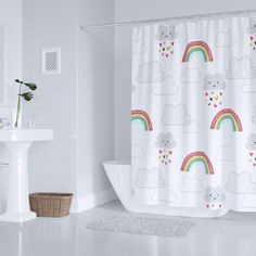 a white bathroom with a rainbow shower curtain