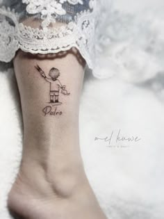 a woman's foot with a small tattoo on it