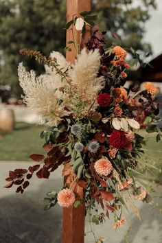 a cross decorated with flowers and greenery