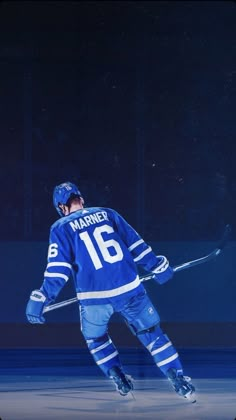 an ice hockey player in blue uniform on the ice