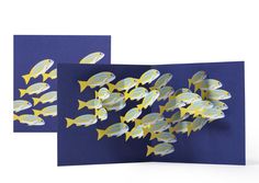 a card with yellow fish on it and blue paper in the middle, which is cut out to look like an ocean scene