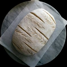 a loaf of bread sitting on top of a piece of wax paper