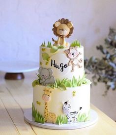 a three tiered cake with animals on it