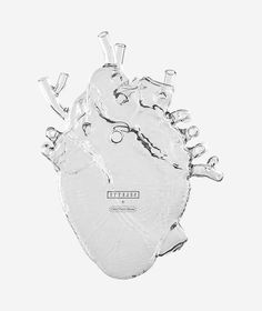 a silver heart shaped object on a white background