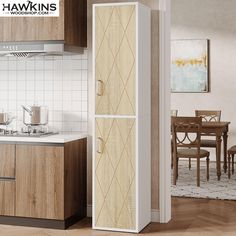 a white refrigerator freezer sitting inside of a kitchen next to a wooden table and chairs