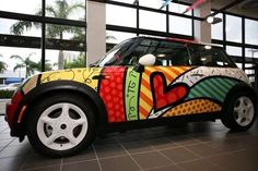 a colorful car is parked in front of some windows