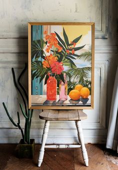 an orange vase with flowers and fruit sits on a small stool in front of a painting