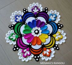 a colorful flower design on the floor with white and black trimmings is featured in this image