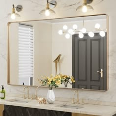 a bathroom with marble counter tops and gold fixtures