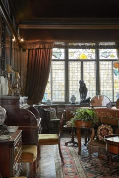 a living room filled with furniture and stained glass windows