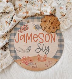 a wooden sign that says jamesonn suy on top of a white fur rug