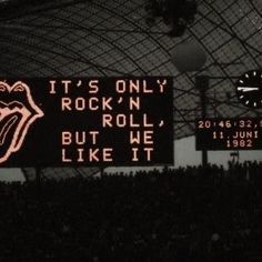 the rolling stones concert sign is lit up in front of an audience at a rock'n'roll concert