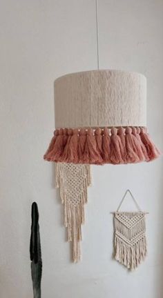 a lamp hanging from the ceiling next to a cactus