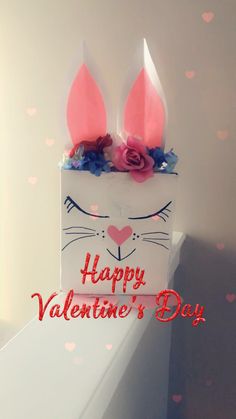 two bunny ears are on top of a valentine's day card with the words happy valentine's day