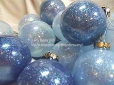 blue christmas balls are piled on top of each other