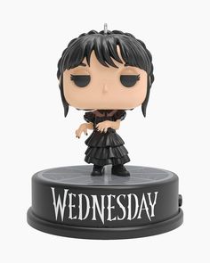 a black and white photo of a figurine with the words wednesday on it