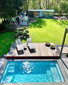 an above ground swimming pool with lounge chairs next to it