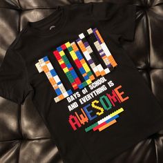 a black t - shirt with the words, days of school and everything is awesome on it