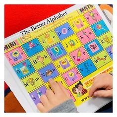 a child is playing with the letter alphabet game