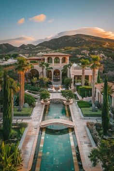 an aerial view of a mansion with a pool in the foreground