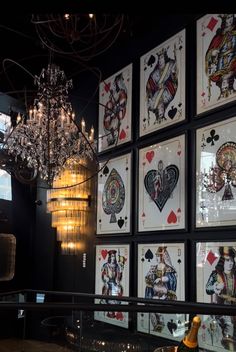 a chandelier hanging from the ceiling next to cards on display in a room